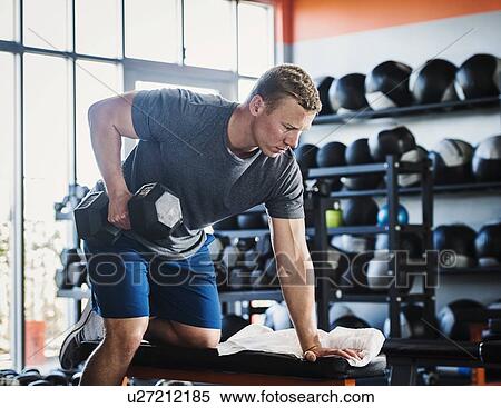 Mid adult man weight lifting View Large Photo Image Stock Photography - Mid adult man weight lifting. Fotosearch