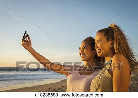 Mother and daughter taking selfie View Large Photo Image Stock Photo - Mother and daughter taking selfie. Fotosearch