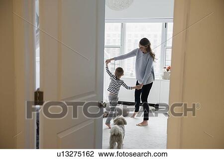 Mother and son (4-5) dancing in room View Large Photo Image Stock Image - Mother and son (4-5) dancing in room. Fotosearch