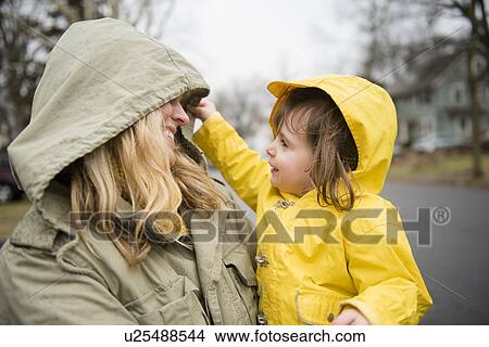 Mother carrying daughter (2-3) outdoors View Large Photo Image Picture - Mother carrying daughter (2-3) outdoors. Fotosearch
