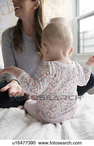 Stock Image - Mother playing with baby (18-23 months). Fotosearch