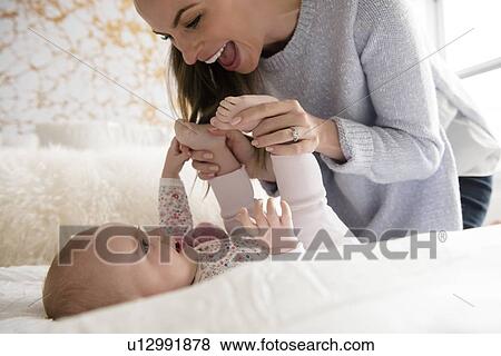 Stock Photo - Mother playing with baby (18-23 months). Fotosearch