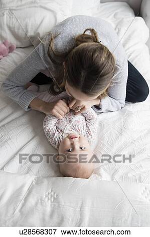 Stock Photo - Mother playing with baby (18-23 months). Fotosearch