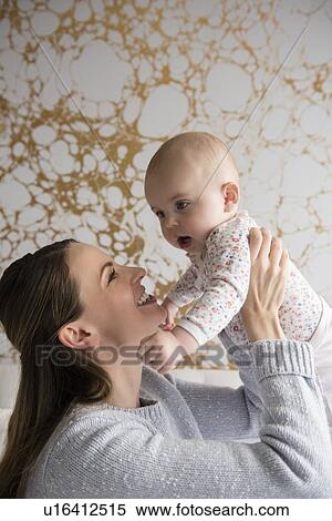 Stock Photography - Mother playing with baby (18-23 months). Fotosearch