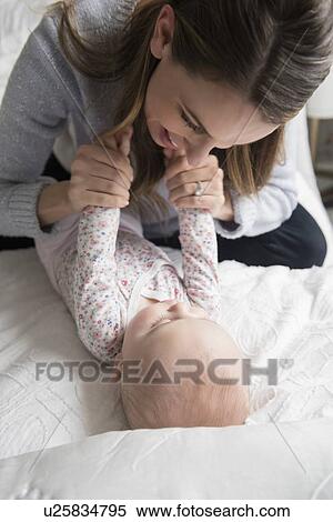 Stock Photography - Mother playing with baby (18-23 months). Fotosearch