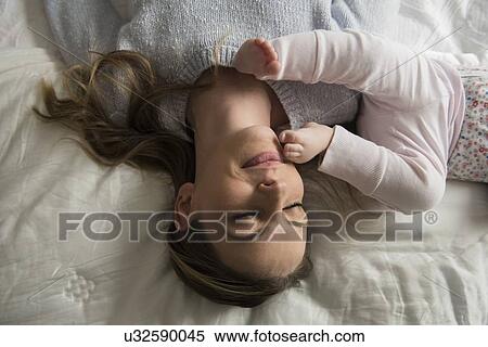 Mother playing with baby (18-23 months) View Large Photo Image Stock Photography - Mother playing with baby (18-23 months). Fotosearch
