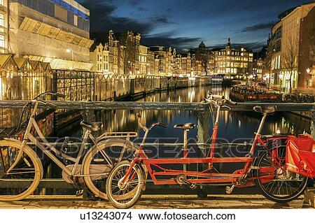 Netherlands, Amsterdam, Bicycle and tandem bicycle on bridge over canal View Large Photo Image Picture - Netherlands, Amsterdam, Bicycle and tandem bicycle on bridge over canal. Fotosearch