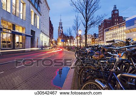 Stock Photo - Netherlands, Amsterdam, Bicycles next to street. Fotosearch