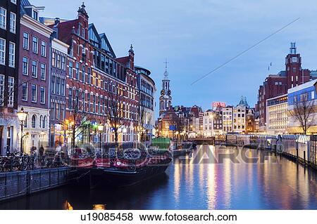 Stock Photo - Netherlands, Amsterdam, Canal at dusk. Fotosearch
