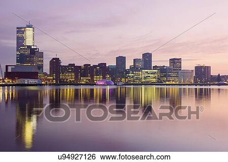 Stock Photograph - Netherlands, Rotterdam, Cityscape at sunrise. Fotosearch