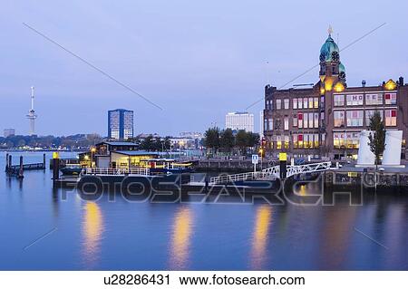 Stock Image - Netherlands, Rotterdam, Empty marina at sunrise. Fotosearch