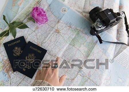 Passports, digital camera and flowers on map View Large Photo Image Stock Image - Passports, digital camera and flowers on map. Fotosearch