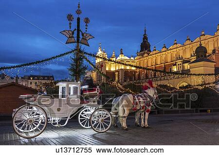 Stock Photography - Poland, Malopolskie, Krakow, Horse carriage in town square. Fotosearch