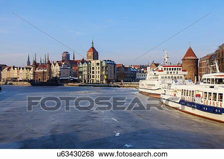 Stock Photo - Poland, Pomerania, Gdansk, Frozen Vistula river and cityscape. Fotosearch