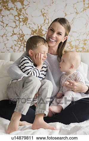 Portrait of happy mother of two children (18-23 months, 4-5) View Large Photo Image Stock Image - Portrait of happy mother of two children (18-23 months, 4-5). Fotosearch