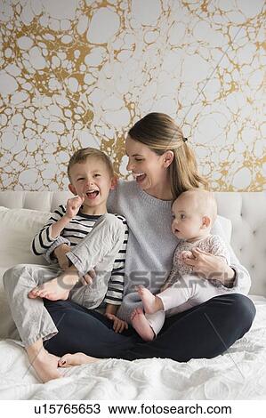Portrait of happy mother of two children (18-23 months, 4-5) View Large Photo Image Stock Image - Portrait of happy mother of two children (18-23 months, 4-5). Fotosearch