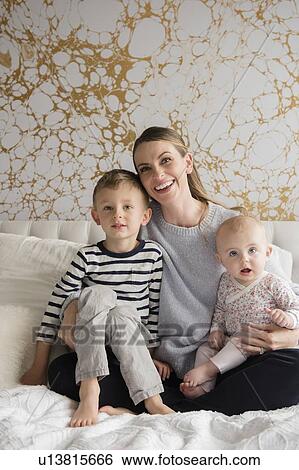 Portrait of happy mother of two children (18-23 months, 4-5) View Large Photo Image Stock Photograph - Portrait of happy mother of two children (18-23 months, 4-5). Fotosearch
