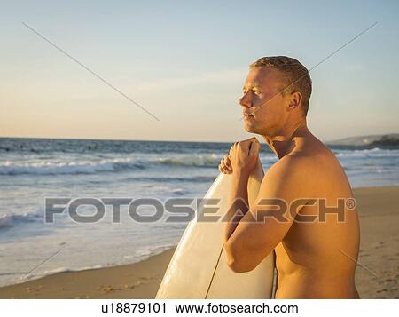 Portrait of man with surfboard View Large Photo Image Stock Image - Portrait of man with surfboard. Fotosearch