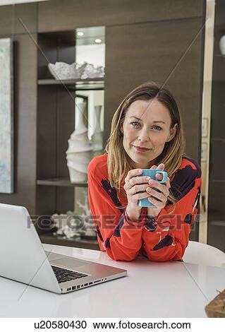 Stock Image - Portrait of mature woman at home. Fotosearch