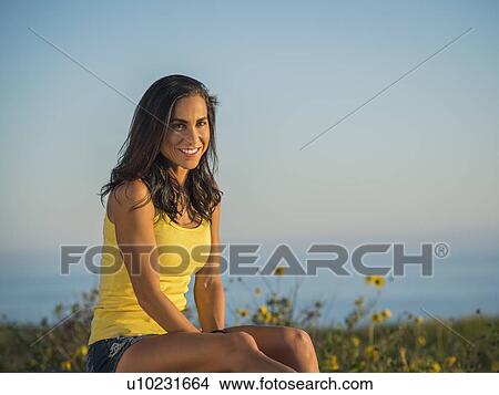 Picture - Portrait of women sitting against clear sky. Fotosearch