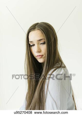 Stock Photo - Portrait of young woman with long brown hair. Fotosearch
