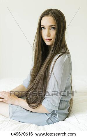 Portrait of young woman with long brown hair View Large Photo Image Stock Photograph - Portrait of young woman with long brown hair. Fotosearch