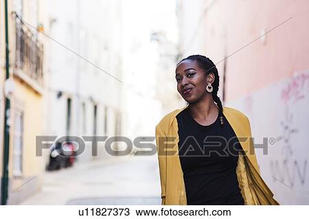 Portugal, Lisbon, Smiling young woman in old town View Large Photo Image Stock Image - Portugal, Lisbon, Smiling young woman in old town. Fotosearch