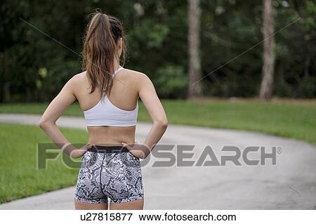 Rear view of woman jogging in park View Large Photo Image Stock Photo - Rear view of woman jogging in park. Fotosearch