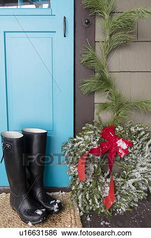 Rubber boots by blue door and wreath in christmas View Large Photo Image Stock Photograph - Rubber boots by blue door and wreath in christmas. Fotosearch