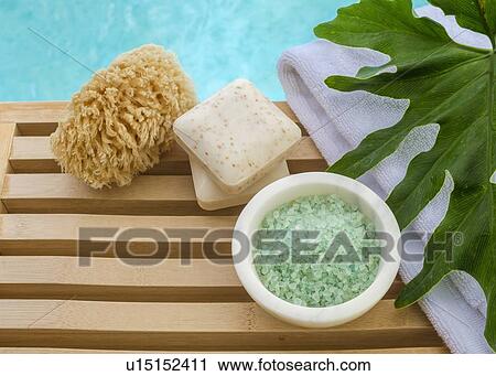 Stock Image - Sea salt and towel for spa treatment. Fotosearch