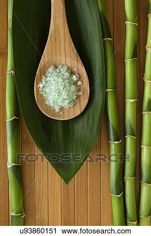 Stock Image - Sea salt with bamboo for spa treatment. Fotosearch