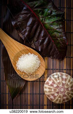 Stock Photo - Sea salt with leaf for spa treatment. Fotosearch