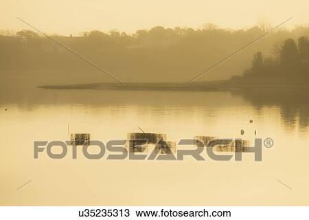 Stock Image - Shellfish baskets at low tide. Fotosearch