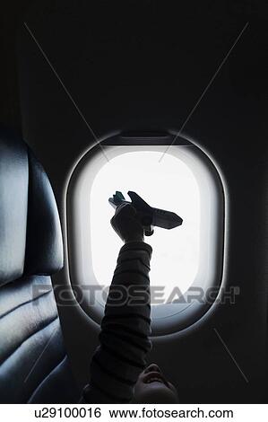 Stock Photograph - Silhouette of girl holding to airplane on airplane. Fotosearch