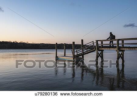 Silhouette of man on pier View Large Photo Image Stock Photograph - Silhouette of man on pier. Fotosearch