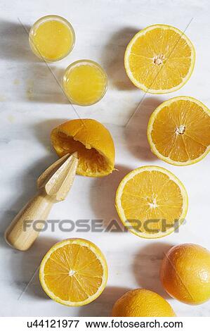 Stock Photo - Sliced oranges with juicer. Fotosearch