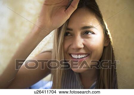 Smiling young woman under blanket View Large Photo Image Picture - Smiling young woman under blanket. Fotosearch