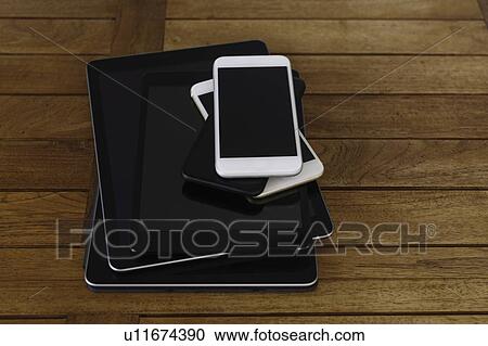 Stock Image - Stack of smart phones and digital tablets. Fotosearch