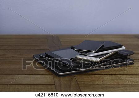 Stock Image - Stack of smart phones and digital tablets. Fotosearch