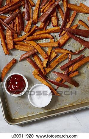 Stock Image - Sweet potato fries with sauces. Fotosearch