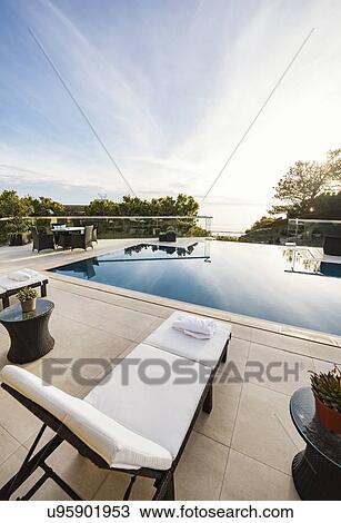 Swimming pool with sun lounger View Large Photo Image Stock Image - Swimming pool with sun lounger. Fotosearch