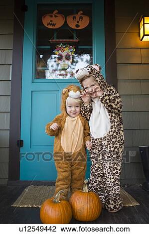 Two kids (2-3, 4-5) wearing Halloween costumes View Large Photo Image Stock Image - Two kids (2-3, 4-5) wearing Halloween costumes. Fotosearch