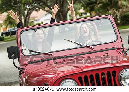 Two young women driving off-road car View Large Photo Image Stock Photography - Two young women driving off-road car. Fotosearch