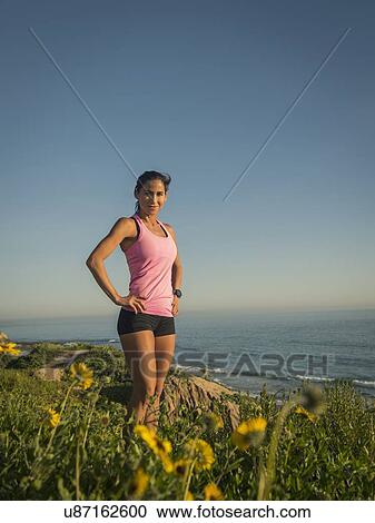USA, California, Newport Beach, Portrait of woman in sport suit standing on cliff View Large Photo Image Stock Image - USA, California, Newport Beach, Portrait of woman in sport suit standing on cliff. Fotosearch