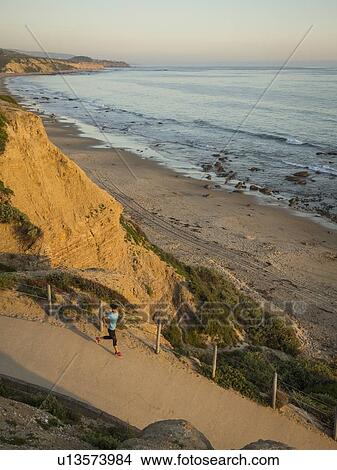 USA, California, Newport Beach, Woman running along footpath View Large Photo Image Picture - USA, California, Newport Beach, Woman running along footpath. Fotosearch
