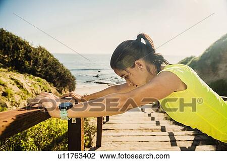 USA, California, Newport Beach, Woman stretching on beach View Large Photo Image Stock Image - USA, California, Newport Beach, Woman stretching on beach. Fotosearch