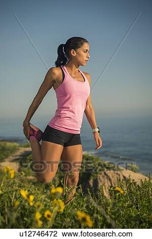 USA, California, Newport Beach, Woman stretching on cliff View Large Photo Image Stock Image - USA, California, Newport Beach, Woman stretching on cliff. Fotosearch