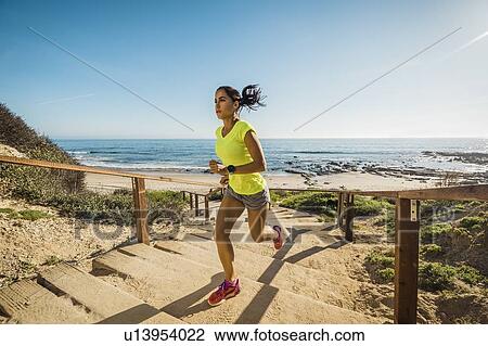 USA, California, Newport Beach, Woman running up stairs View Large Photo Image Stock Image - USA, California, Newport Beach, Woman running up stairs. Fotosearch