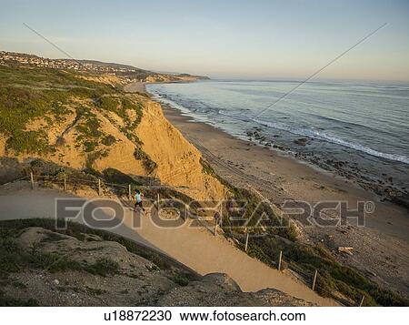 USA, California, Newport Beach, Woman running along footpath View Large Photo Image Stock Image - USA, California, Newport Beach, Woman running along footpath. Fotosearch
