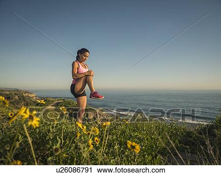 USA, California, Newport Beach, Woman stretching on cliff View Large Photo Image Stock Image - USA, California, Newport Beach, Woman stretching on cliff. Fotosearch